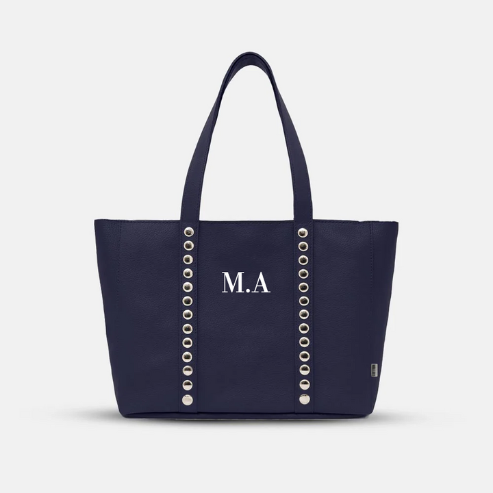 Navy blue personalized tote bag with silver eyelet detailing and initials M.A. on front